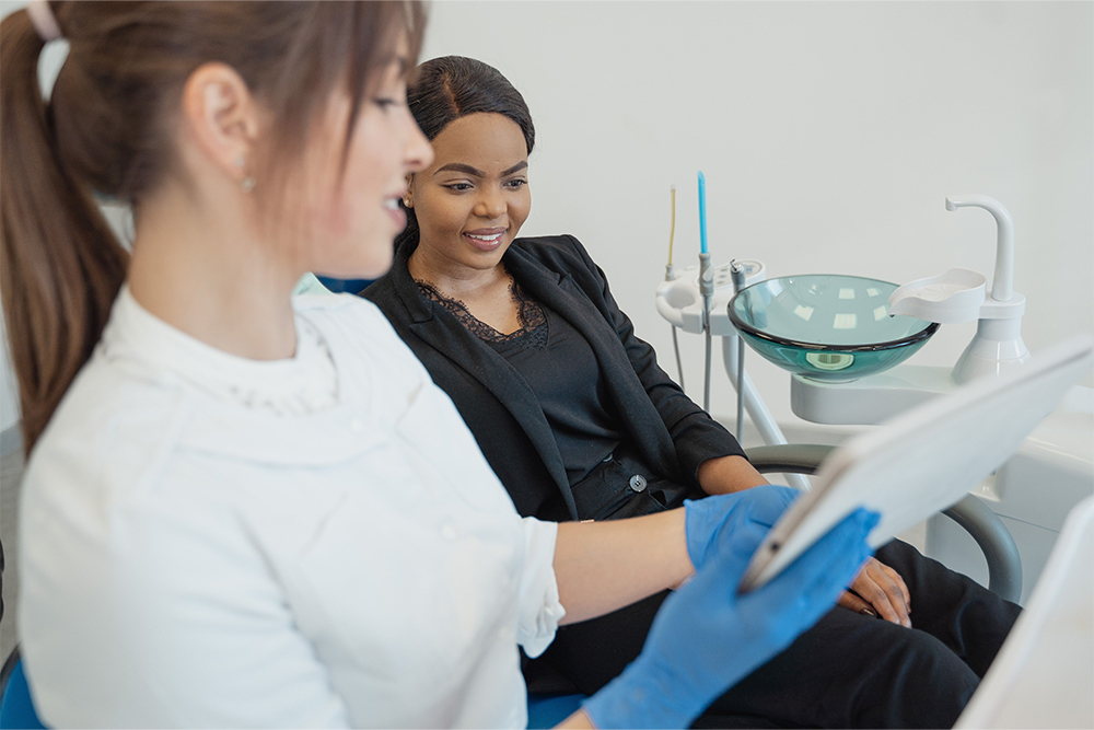 Patient discussing dental implants and dentures with a dentist in Cambridge
